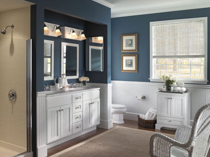 Bathroom with white cabinets and dark blue walls