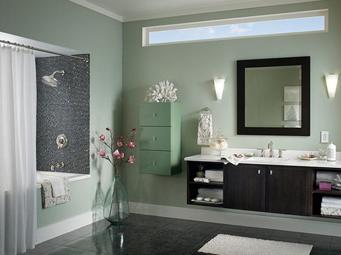 Bathroom with green walls and dark wood cabinets