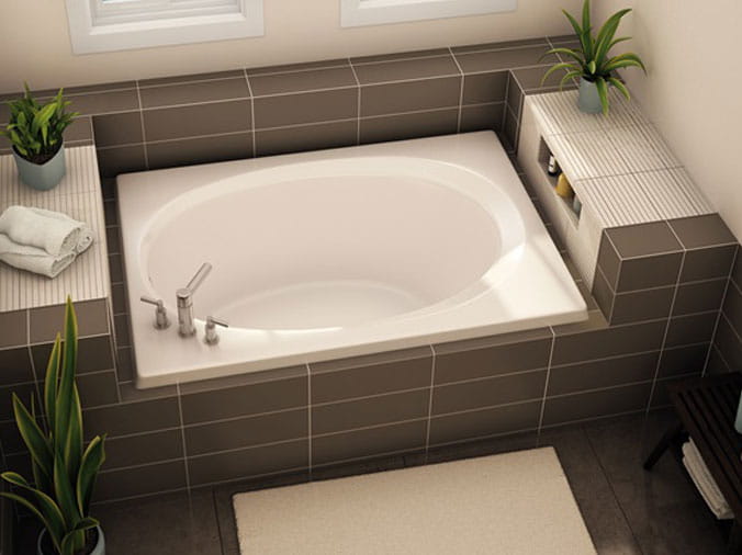 Large bathtub with tile exterior