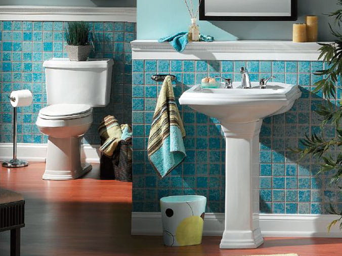 Bathroom with aqua blue tile walls and whte Gerber toilet and sink