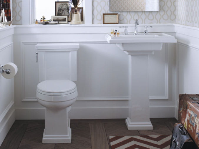 White bathroom with Kohler toilet and pedistal sink