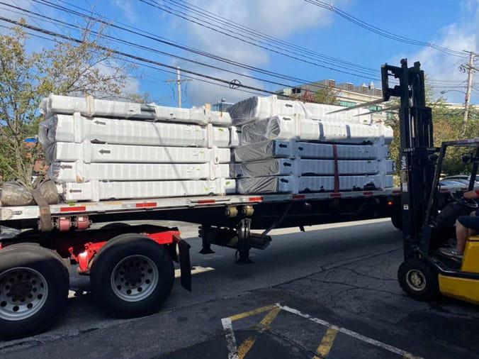 Plumbing supplies being loaded onto a delivery truck at Peabody Supply Watham MA